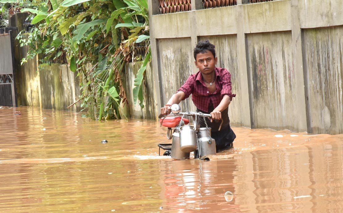 People wade through flood engulf road in Anil Nagar area on 07-07-16. Pix by UB Photos  