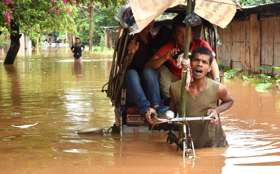 People using rickshaw to cross the flood engulf road in Anil Nagar area on 07-07-16. Pix by UB Photos  