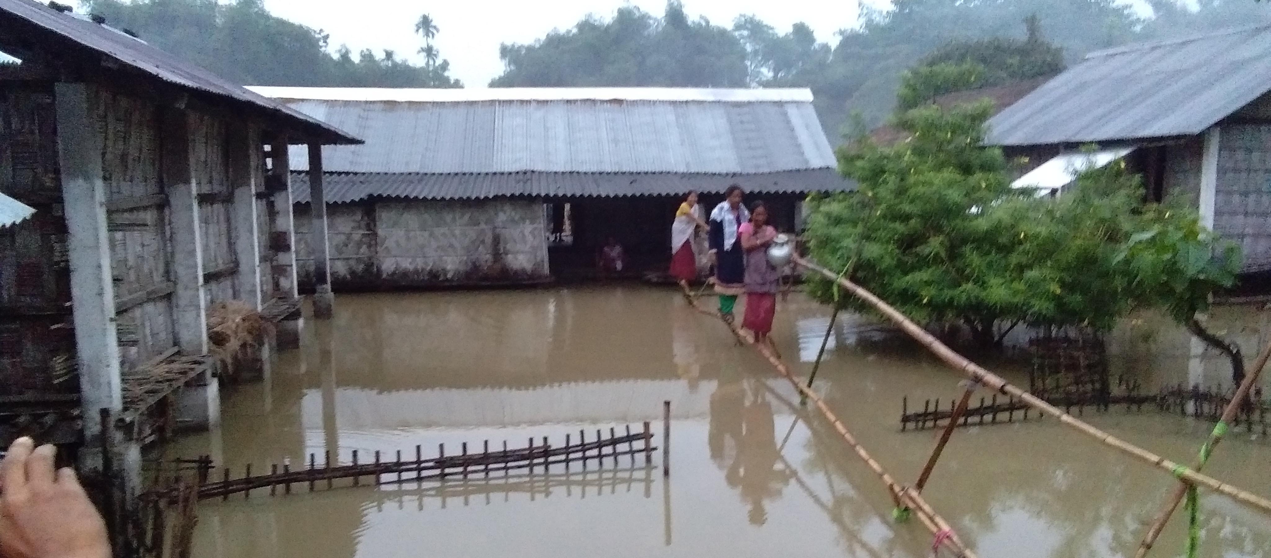 Houses submerged under flood due to heavy shower in the last few days at Tinsukia on Saturday.  Photo by UB Photos.