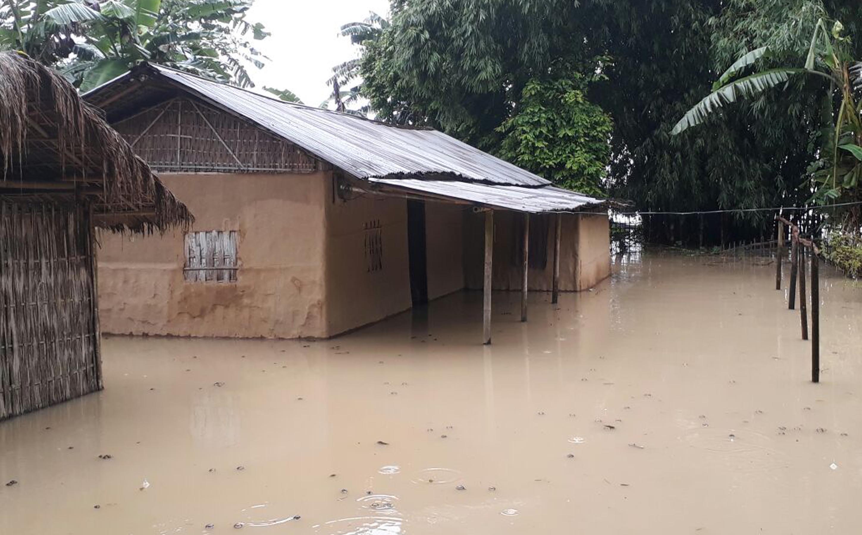 Houses submerged under flood due to heavy shower in the last few days at Tinsukia on Saturday. / UB Photos
