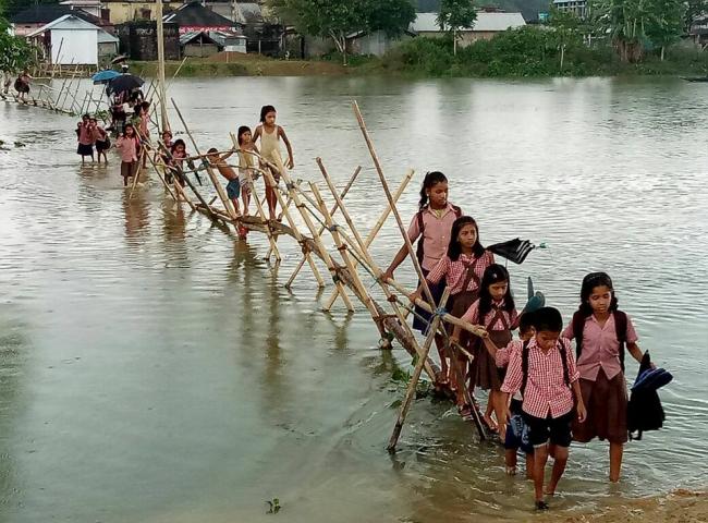 School children are facing hardship in communication to their school in Karimganj district because of flood