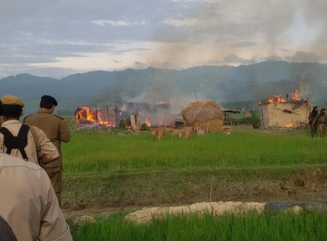The burnung hemlet: thatched houses set on fire by miscreants in Uriam Ghat area. Photo: Bibeka Dutta