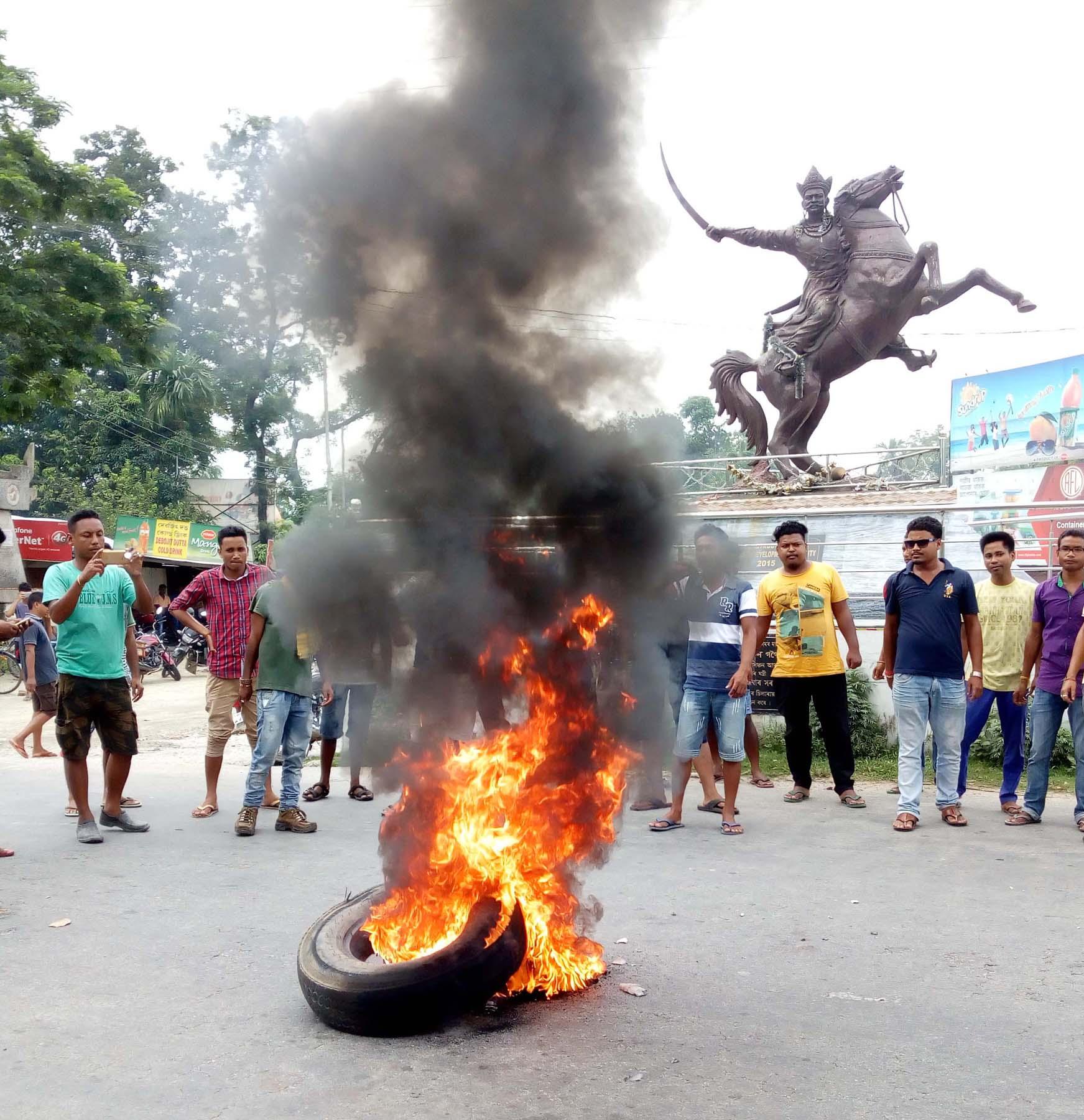 Protesters  burning tyres on National Highway-31 during 48 hours Assam Bandh called by Assam Koch Rajbongshi Students' Union (AKRASU) at Uttar Salmara in Abhayapuri in onThursday. Photo by UB Photos